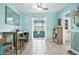 Dining area with tile floors, blue walls, beach decor, and plenty of seating with a view into the sunroom at 111 Claire Ter, Daytona Beach, FL 32118