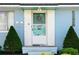 Charming front entry with tiled trim, screen door, and manicured shrubs at 111 Claire Ter, Daytona Beach, FL 32118