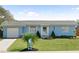 Charming one-story home with light blue paint, a well-manicured lawn, and tasteful landscaping at 111 Claire Ter, Daytona Beach, FL 32118