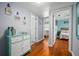 Hallway featuring wood floors, blue and grey walls, with views to bedroom and access to other rooms at 111 Claire Ter, Daytona Beach, FL 32118