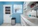 Stylish kitchen boasts white cabinets, double sink, marble countertops, and a view of the outdoors from the window at 111 Claire Ter, Daytona Beach, FL 32118