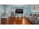 Cozy living room featuring hardwood floors, blue walls, beach decor, and a comfortable sofa at 111 Claire Ter, Daytona Beach, FL 32118