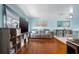 Open-concept living space with hardwood floors, blue walls, beach decor, and a dining area at 111 Claire Ter, Daytona Beach, FL 32118