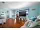 Inviting living room with hardwood floors, blue accent walls, comfortable seating, and beach-themed decor at 111 Claire Ter, Daytona Beach, FL 32118