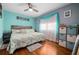 Cozy main bedroom with wood floors, natural light, and stylish decor to create a calming and inviting space at 111 Claire Ter, Daytona Beach, FL 32118