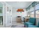 Bright sunroom featuring desk, seating, and views of outside; perfect for relaxing or as a home office space at 111 Claire Ter, Daytona Beach, FL 32118