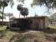 Home with screened in back porch, door to back yard, and mature shady trees at 1151 Deltona Blvd, Deltona, FL 32725