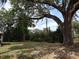 A large shade tree graces this home's spacious backyard at 1151 Deltona Blvd, Deltona, FL 32725