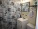 Functional bathroom with a vanity, floral shower curtain and tile flooring at 1151 Deltona Blvd, Deltona, FL 32725