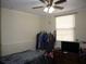 Modest bedroom with a ceiling fan, window and a rack of clothes at 1151 Deltona Blvd, Deltona, FL 32725