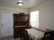 Cozy dining room with a vintage wood china cabinet and patterned tablecloth at 1151 Deltona Blvd, Deltona, FL 32725