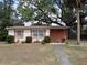 Charming single story home with red tile roof and simple, nicely maintained landscaping at 1151 Deltona Blvd, Deltona, FL 32725