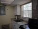 Functional kitchen area featuring stainless steel sink, granite countertop, and white cabinetry at 1151 Deltona Blvd, Deltona, FL 32725