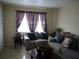 Comfortable living room featuring a sofa, plants, and natural light at 1151 Deltona Blvd, Deltona, FL 32725