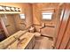 This bathroom features a double sink vanity, tiled floors, and a shower with grab bars at 1167 Peachtree Rd, Daytona Beach, FL 32114