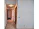 A hallway with tan carpet leads to bedrooms and closets at 1167 Peachtree Rd, Daytona Beach, FL 32114