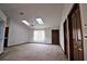 Spacious living room featuring natural light, neutral carpet, and multiple closets at 1167 Peachtree Rd, Daytona Beach, FL 32114