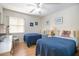 This bedroom offers twin beds, ceiling fan and light wood flooring at 120 Hibiscus Woods Ct # 2A, Deltona, FL 32725