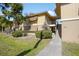 Inviting two-story condo with well-maintained landscaping and sidewalk entry at 120 Hibiscus Woods Ct # 2A, Deltona, FL 32725