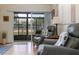 Cozy sunroom with sliding glass door, comfortable seating, and natural light at 120 Hibiscus Woods Ct # 2A, Deltona, FL 32725