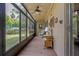 Enclosed patio with tiled floors, ceiling fan, and serene outdoor views at 120 Hibiscus Woods Ct # 2A, Deltona, FL 32725
