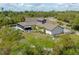 Aerial shot of the property highlighting the pool, outdoor living space and surrounding landscape at 125 Smyrna Dr, Debary, FL 32713