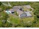 An aerial perspective displays the home's layout, pool, expansive yard and landscaping at 125 Smyrna Dr, Debary, FL 32713