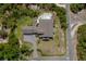 Aerial view showcasing this estate's sprawling layout, pool, lush landscaping and surrounding woods at 125 Smyrna Dr, Debary, FL 32713