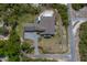 Stunning aerial view of home, showcasing pool, patio, landscaping, circular driveway, and lush surroundings at 125 Smyrna Dr, Debary, FL 32713