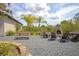 Backyard featuring a stone fireplace, picnic table, Adirondack chairs, and beautiful trees at 125 Smyrna Dr, Debary, FL 32713