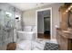 Stylish bathroom features marble tile, walk-in shower, modern soaker tub and a door to a hallway at 125 Smyrna Dr, Debary, FL 32713