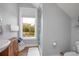 Bright bathroom featuring a large window, shower, and single sink at 125 Smyrna Dr, Debary, FL 32713