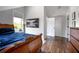 Bedroom featuring bed with blue covers, wood floors, and an outdoor view at 125 Smyrna Dr, Debary, FL 32713