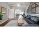 Large upstairs bonus room with hardwood floors, an upstairs hall, and a large dark sofa at 125 Smyrna Dr, Debary, FL 32713