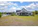 Exterior view of the house showing the expansive lawn and grand facade at 125 Smyrna Dr, Debary, FL 32713