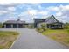 Front exterior of home with three car garage, a basketball hoop, and lush landscaping at 125 Smyrna Dr, Debary, FL 32713
