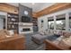 Cozy living room featuring a stone fireplace, custom built-ins, and large windows for natural light at 125 Smyrna Dr, Debary, FL 32713