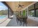 Covered patio with wooden ceiling, dining area, and view of the pool at 125 Smyrna Dr, Debary, FL 32713