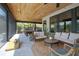 Screened-in patio with cozy seating, pool table, and stylish outdoor decor at 125 Smyrna Dr, Debary, FL 32713