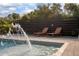 Lounge by this backyard pool area featuring stone tiling, relaxing chaise lounges, and a fountain feature at 125 Smyrna Dr, Debary, FL 32713