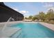 Backyard pool featuring a deck lounge area, beautiful landscaping, and a refreshing fountain feature at 125 Smyrna Dr, Debary, FL 32713
