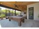 Entertain in this sunroom, featuring a wood ceiling, recessed lighting, and a classic billiards table at 125 Smyrna Dr, Debary, FL 32713