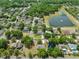 Aerial view showing a neighborhood with lush landscaping and a pond at 1253 Bramley Ln, Deland, FL 32720