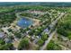 Aerial view of a neighborhood showcasing mature trees, pond, and well-maintained homes at 1253 Bramley Ln, Deland, FL 32720