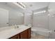 This bathroom features white cabinets, a large mirror, and a shower-tub combination at 1253 Bramley Ln, Deland, FL 32720