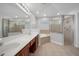 Bright bathroom showcasing double vanity, soaking tub, and glass-enclosed shower at 1253 Bramley Ln, Deland, FL 32720