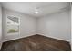 This bright bedroom features a ceiling fan, wood floors, and a view of the outdoors at 1253 Bramley Ln, Deland, FL 32720