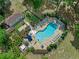 Aerial shot of a community pool surrounded by landscaping, lounge chairs, and seating areas at 1253 Bramley Ln, Deland, FL 32720