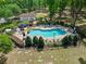 Community pool and lounging area surrounded by lush landscaping and mature trees at 1253 Bramley Ln, Deland, FL 32720