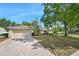 Charming home with a well-manicured lawn, mature trees, and a brick driveway at 1253 Bramley Ln, Deland, FL 32720